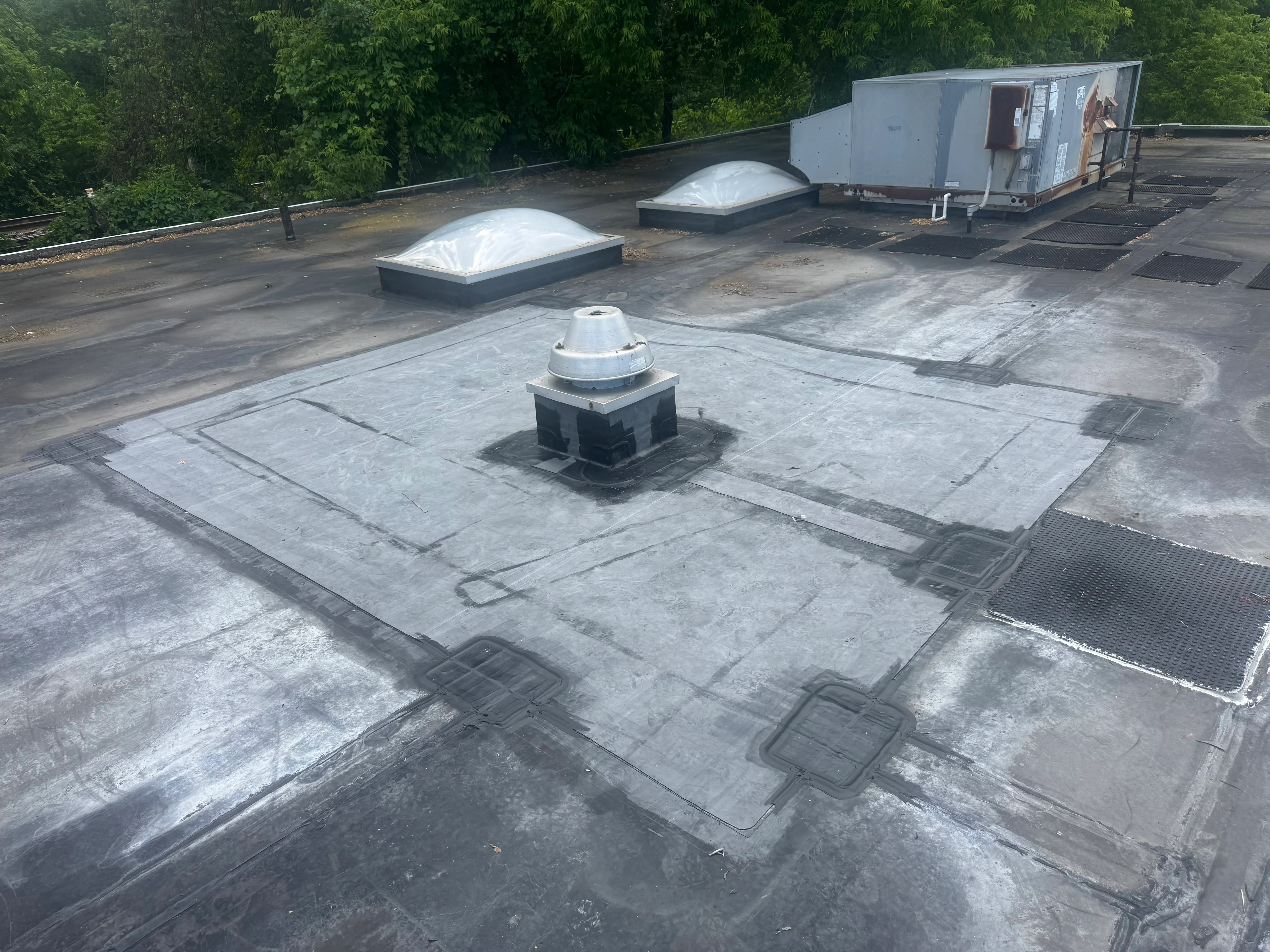 Flat roof with modified bitumen membrane, skylight domes, and HVAC penetrations